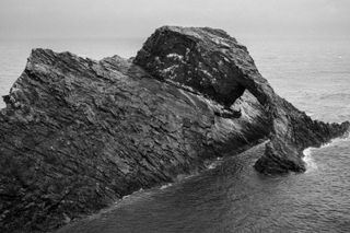 Black and white picture of the Bow Fiddle rock in Scotland