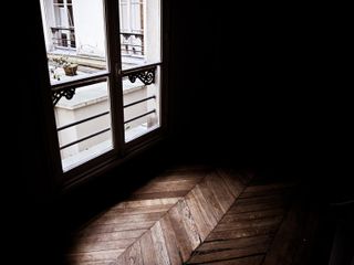 Light going through a dark staircase in an old parisian building